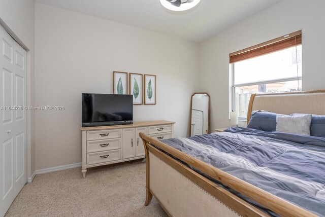 carpeted bedroom with a closet