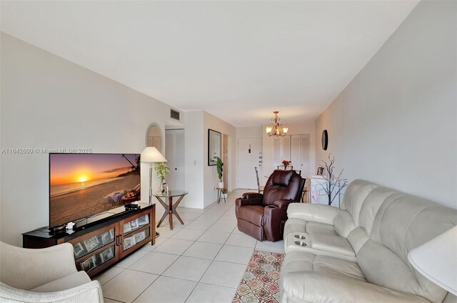 living room with a notable chandelier and light tile patterned floors