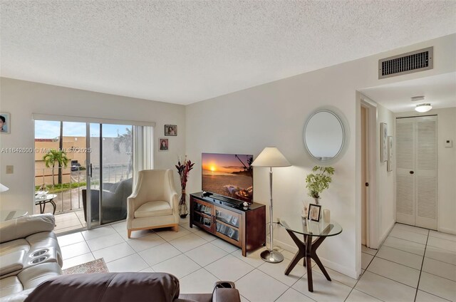 tiled living room with a textured ceiling