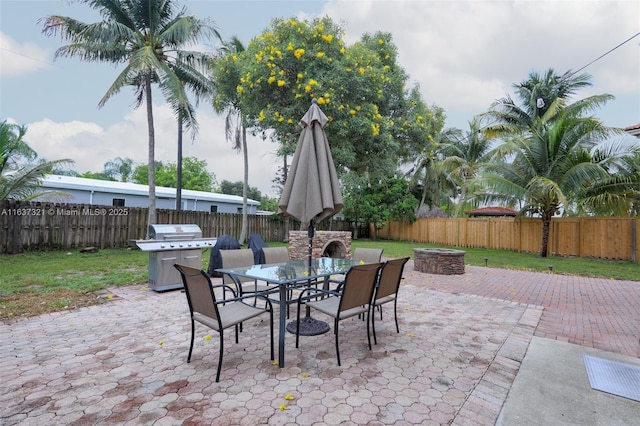 view of patio / terrace featuring grilling area and a fire pit