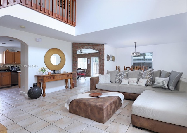 tiled living room with a high ceiling and a healthy amount of sunlight