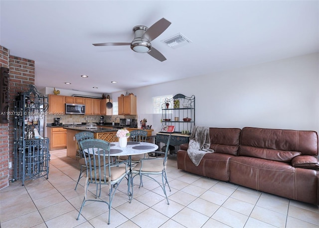 dining space with ceiling fan and light tile patterned floors