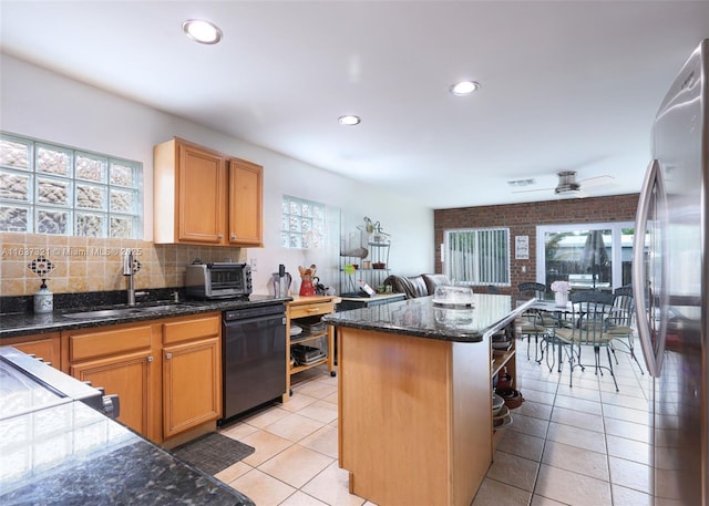 kitchen with dishwasher, stainless steel refrigerator, a healthy amount of sunlight, and sink