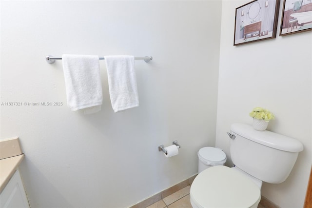 bathroom featuring toilet, vanity, and tile patterned floors