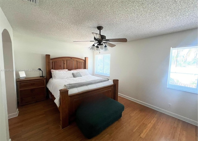 bedroom featuring a textured ceiling, dark hardwood / wood-style flooring, and ceiling fan