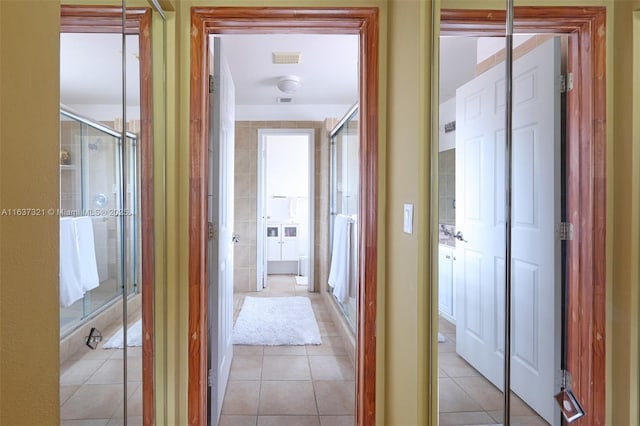 corridor featuring light tile patterned floors