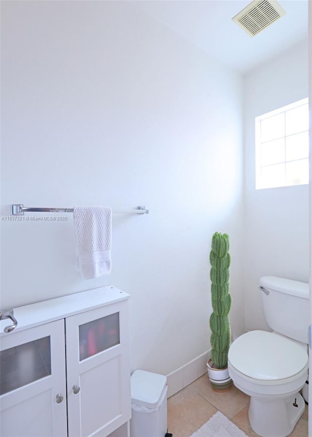 bathroom with toilet and tile patterned floors