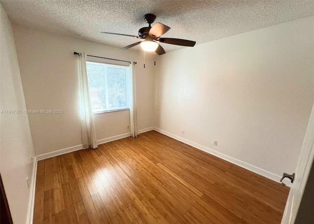 spare room with wood-type flooring, a textured ceiling, and ceiling fan