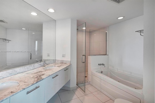 bathroom featuring separate shower and tub, double vanity, and tile patterned floors