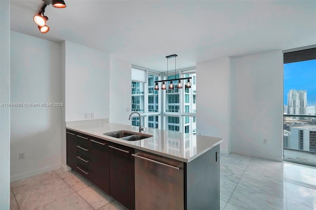 kitchen featuring rail lighting, dark brown cabinets, sink, a wall of windows, and light tile patterned flooring