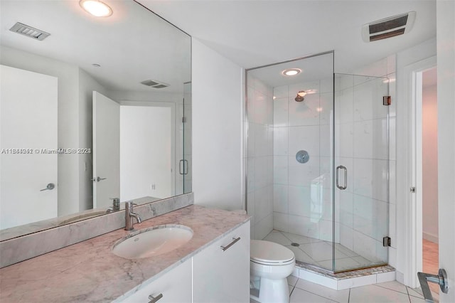 bathroom featuring tile patterned floors, vanity, walk in shower, and toilet