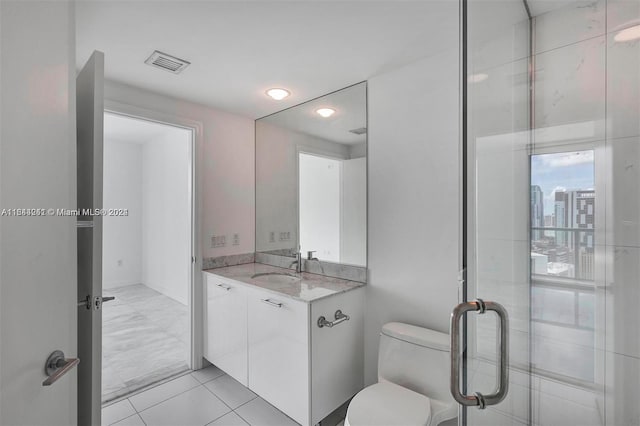 bathroom featuring tile patterned floors, vanity, and toilet