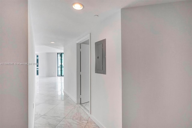 corridor with electric panel and light tile patterned floors