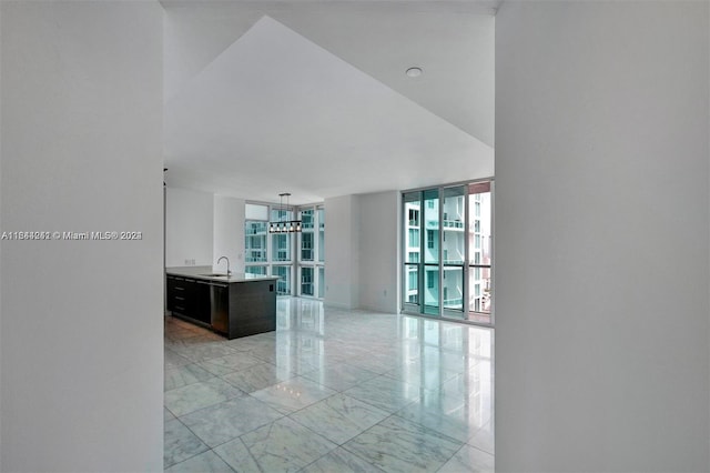 interior space featuring sink, floor to ceiling windows, and light tile patterned floors