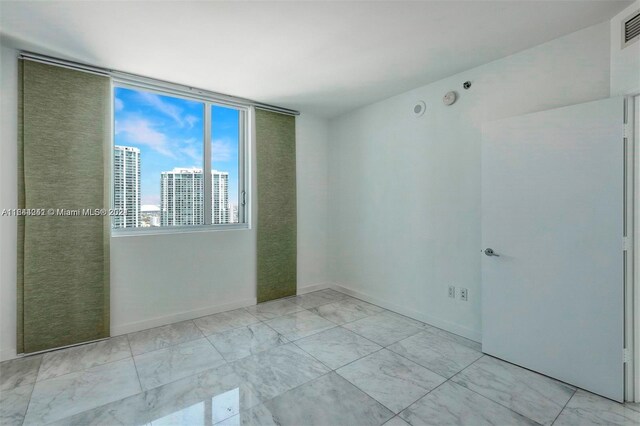 empty room featuring light tile patterned floors