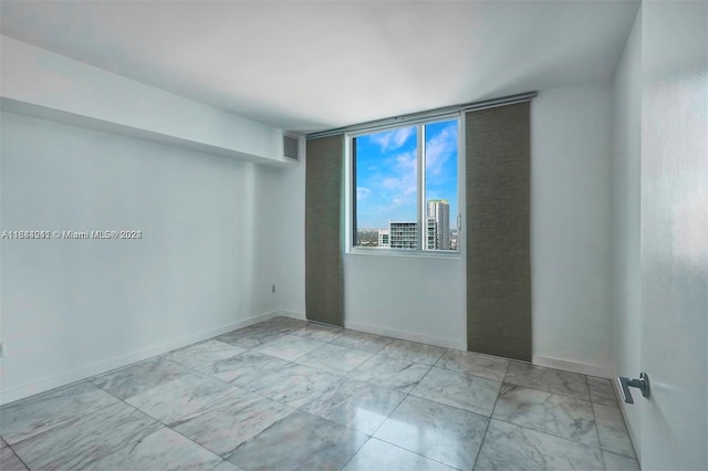 spare room with light tile patterned floors