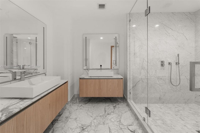 bathroom featuring tile patterned flooring, a shower with door, and dual vanity