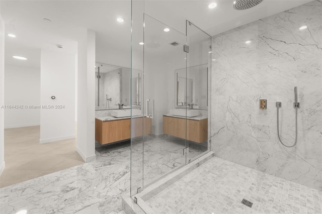 bathroom featuring a shower with shower door, tile patterned flooring, and vanity