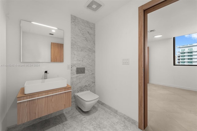 bathroom featuring tile patterned floors, vanity, and toilet