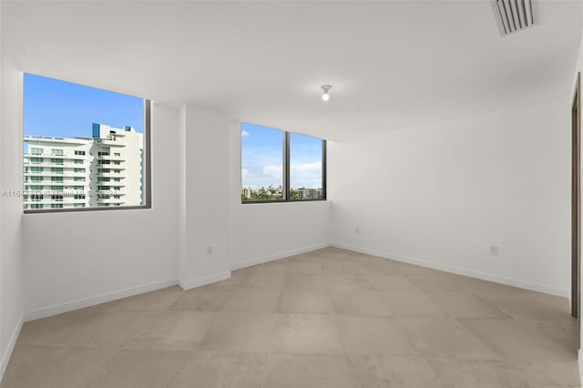 spare room with light tile patterned floors