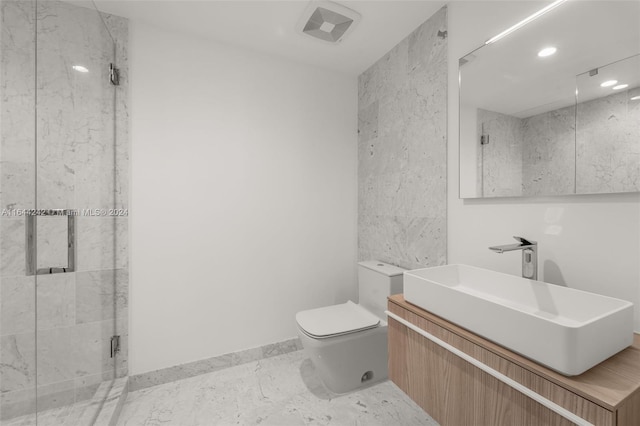 bathroom with tile patterned flooring, a tile shower, vanity, and toilet