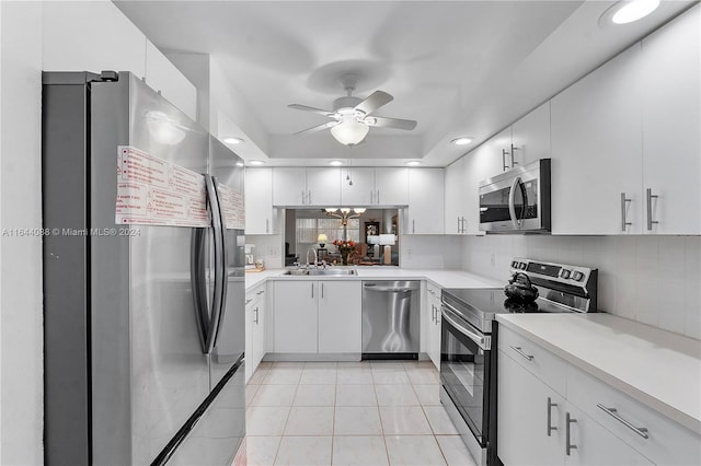 kitchen featuring backsplash, stainless steel appliances, sink, light tile patterned floors, and ceiling fan