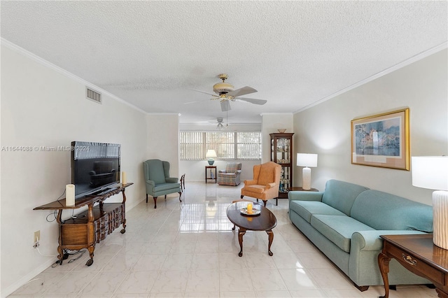 tiled living room with ceiling fan, ornamental molding, and a textured ceiling