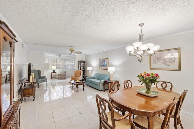 dining area featuring ceiling fan with notable chandelier, a textured ceiling, crown molding, and light tile patterned floors