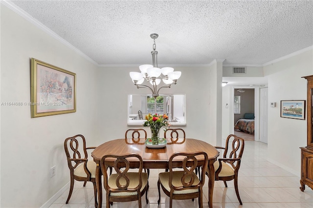 tiled dining room featuring a textured ceiling, ornamental molding, and an inviting chandelier