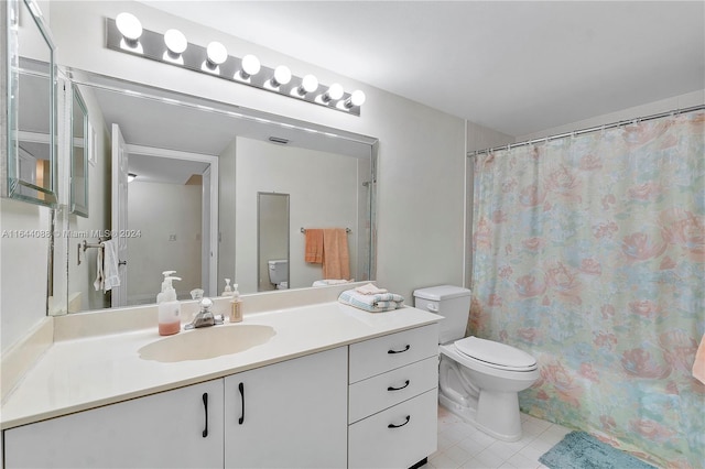 bathroom with tile patterned floors, vanity, and toilet