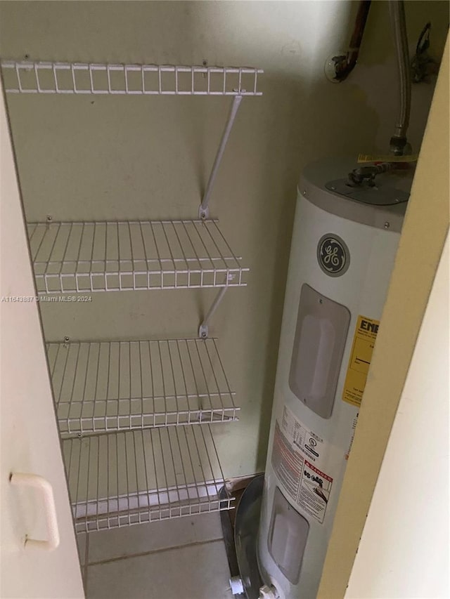 utility room featuring water heater