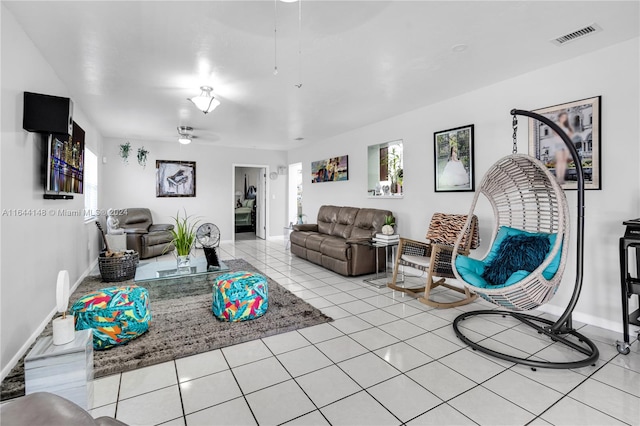 living room with ceiling fan and light tile patterned flooring