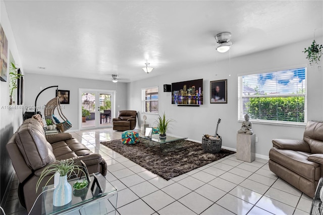 living room with ceiling fan, light tile patterned floors, and french doors