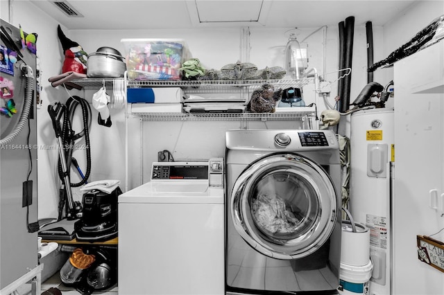 washroom featuring electric water heater and separate washer and dryer