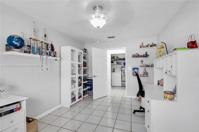 tiled home office featuring ceiling fan and washer and dryer