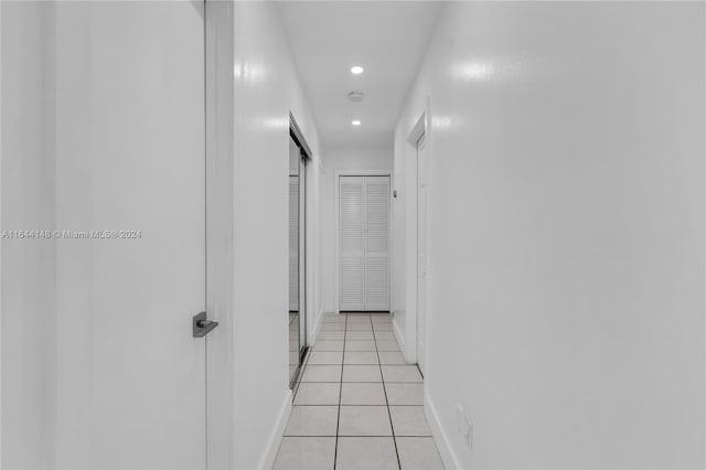 hall featuring light tile patterned floors