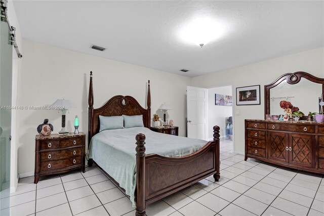 bedroom with light tile patterned floors