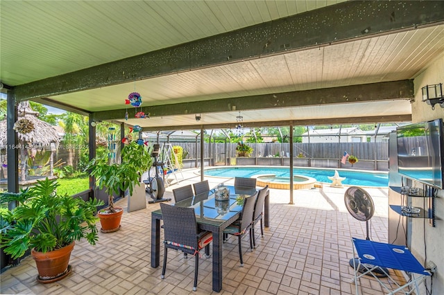 view of patio / terrace with a pool with hot tub