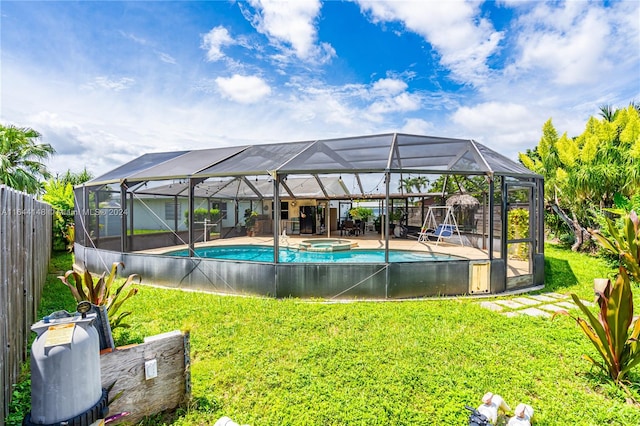 view of swimming pool featuring a patio, a lanai, and a lawn