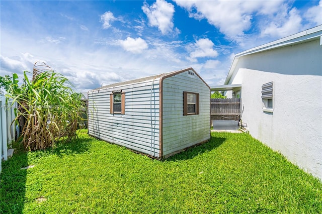 view of outdoor structure featuring a lawn