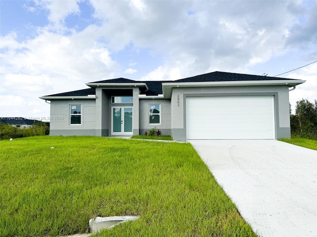 view of front of home featuring a garage and a front lawn