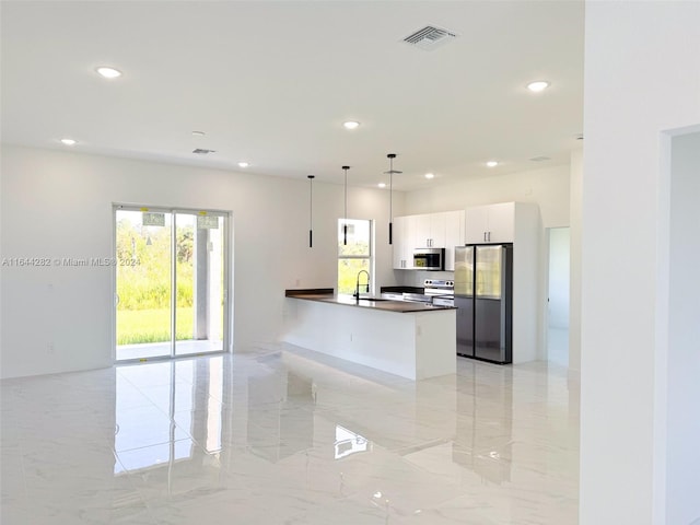 kitchen with white cabinetry, appliances with stainless steel finishes, sink, and hanging light fixtures