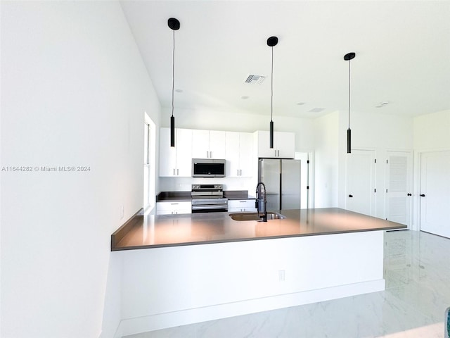 kitchen featuring white cabinetry, pendant lighting, sink, and stainless steel appliances