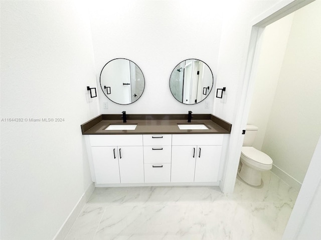 bathroom featuring toilet and vanity