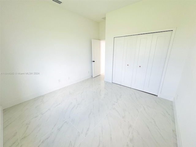 unfurnished bedroom with a closet