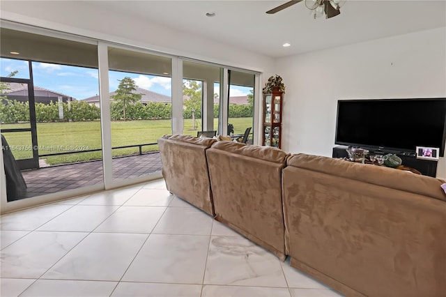 living area featuring light tile patterned floors, recessed lighting, a healthy amount of sunlight, and a ceiling fan