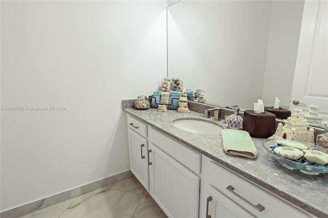 bathroom featuring tile patterned floors, vanity, and baseboards