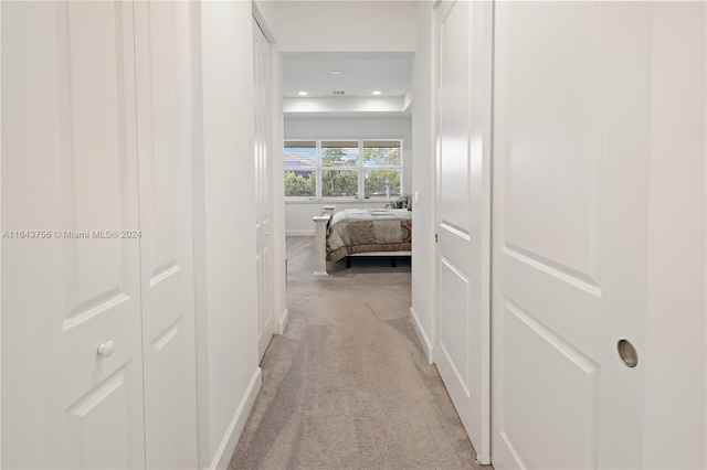 hall with recessed lighting, baseboards, and light carpet