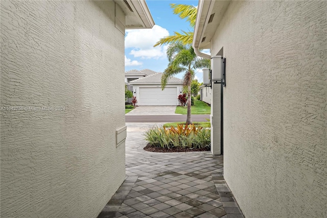 view of patio / terrace featuring concrete driveway and a garage