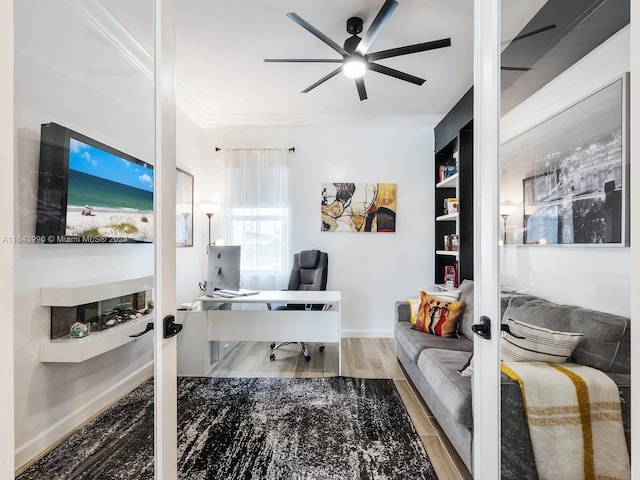 office with crown molding, french doors, hardwood / wood-style flooring, and ceiling fan